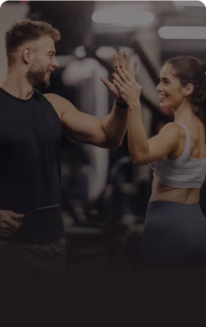 Personal trainer and client cheer after a workout
